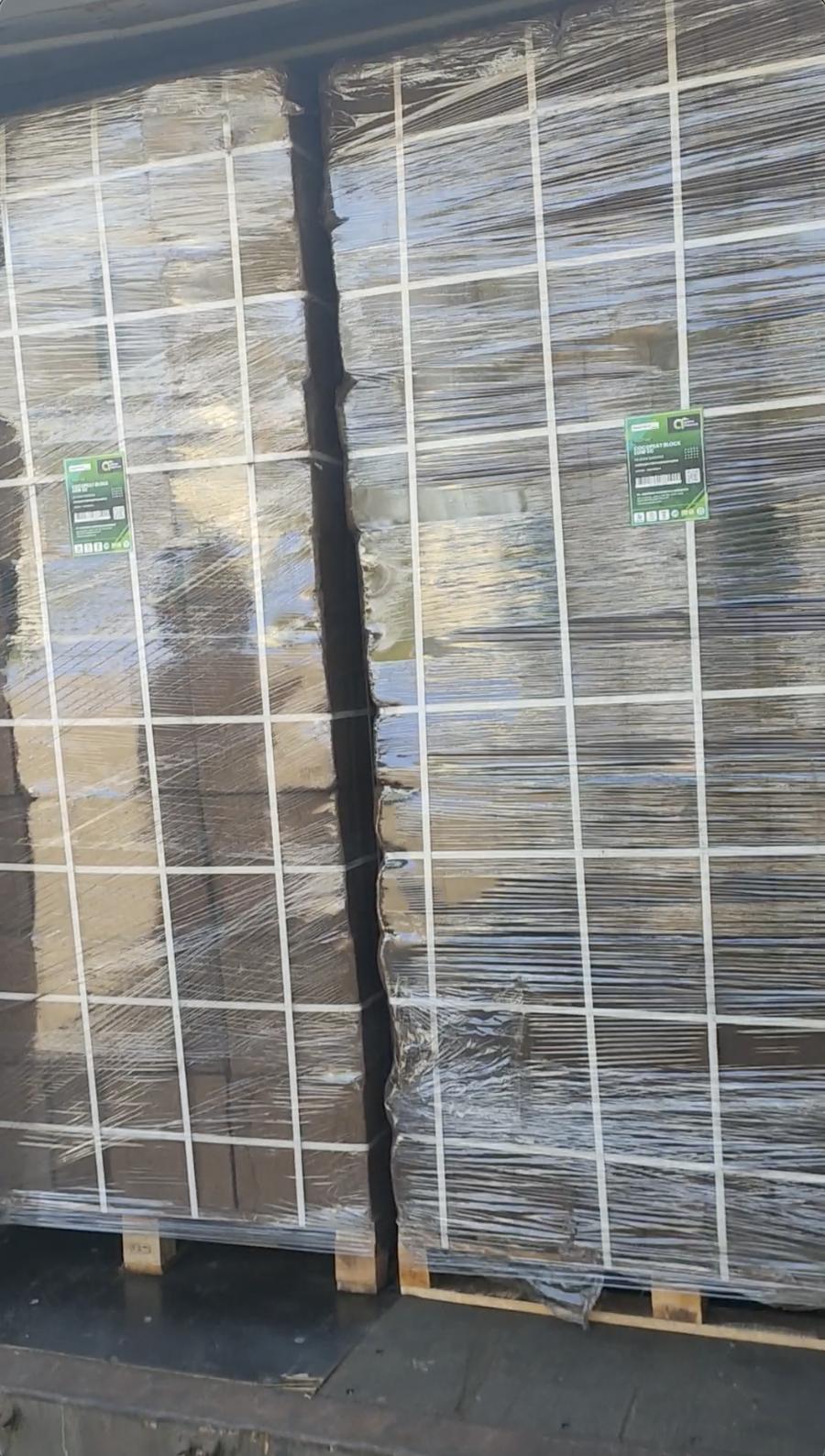 Labeled pallets of cocopeat blocks stuffed inside a container
